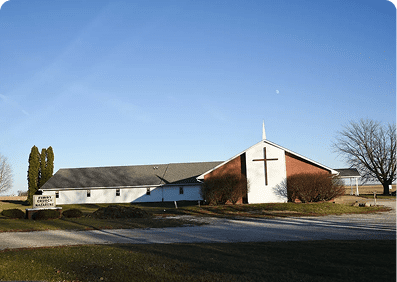 Rural church exterior with trees