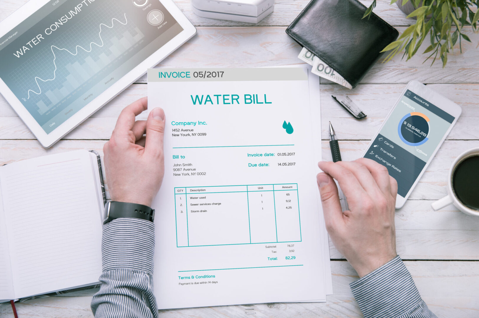 Hands holding a water bill document