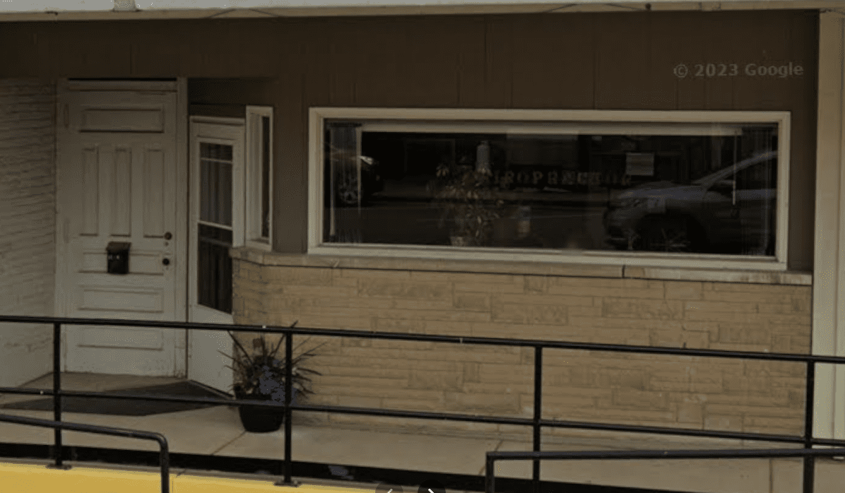 Building entrance with large window and ramp